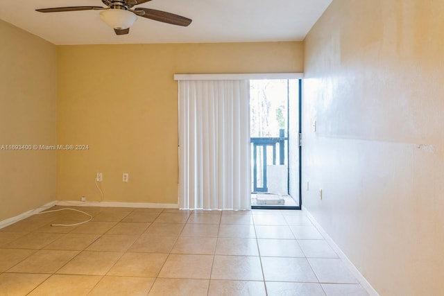 spare room with ceiling fan and light tile patterned flooring