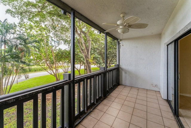 unfurnished sunroom featuring ceiling fan and a wealth of natural light