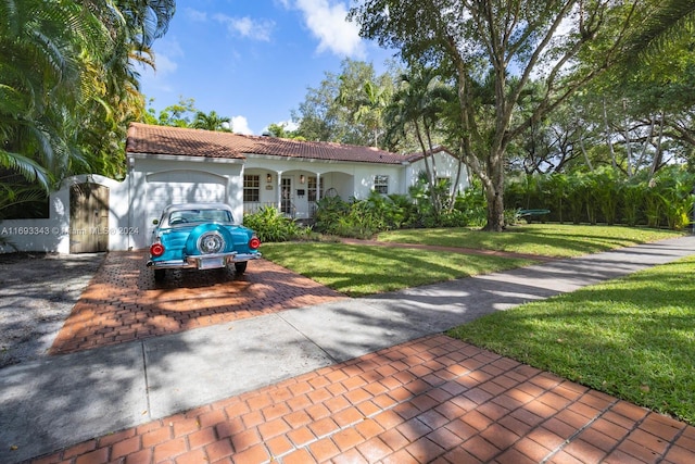 mediterranean / spanish home with a front yard