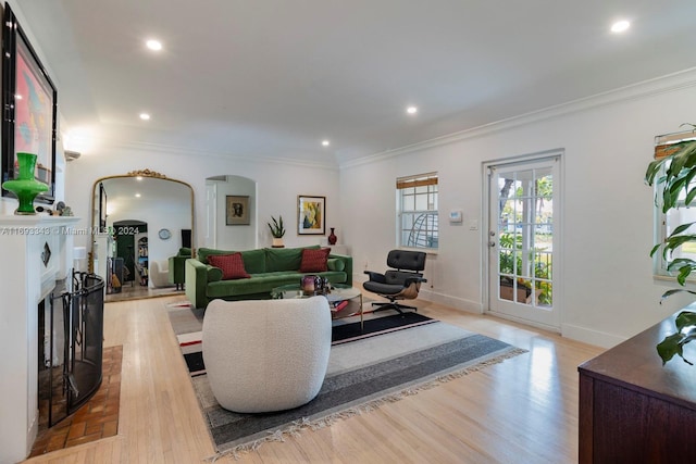 living room featuring light wood-type flooring and ornamental molding