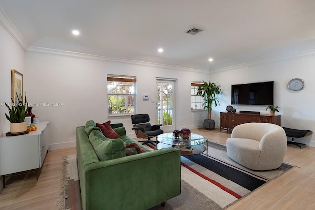 living room with light wood-type flooring and crown molding