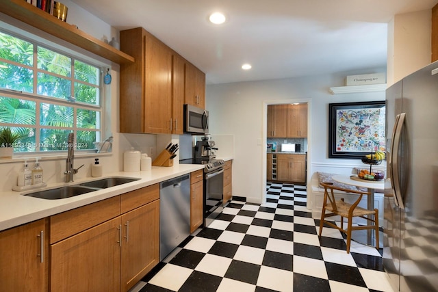 kitchen featuring backsplash, sink, and stainless steel appliances