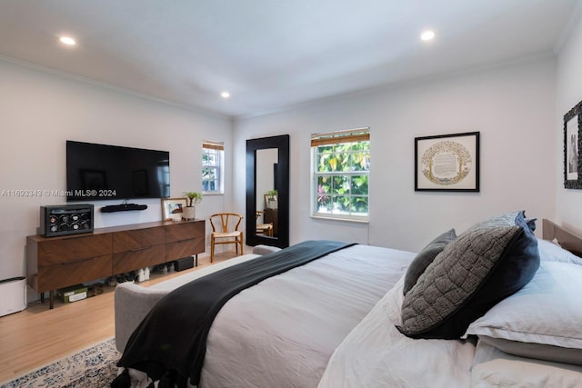 bedroom featuring wood-type flooring and crown molding