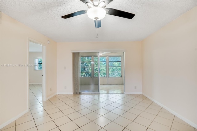 tiled empty room with a textured ceiling and ceiling fan