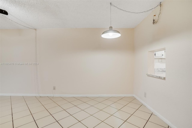 unfurnished room with a textured ceiling