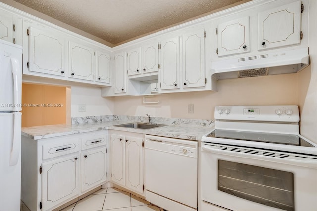 608 SW Natura Blvd Unit 311, Deerfield Beach, FL 33441 - kitchen with white appliances, under cabinet range hood, a textured ceiling, light countertops, and light tile patterned floors