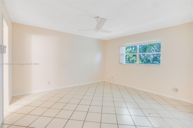 spare room featuring ceiling fan and light tile patterned floors