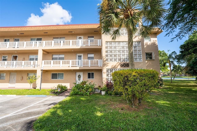 608 SW Natura Blvd Unit 311, Deerfield Beach, FL 33441 - view of apartment building / complex featuring uncovered parking
