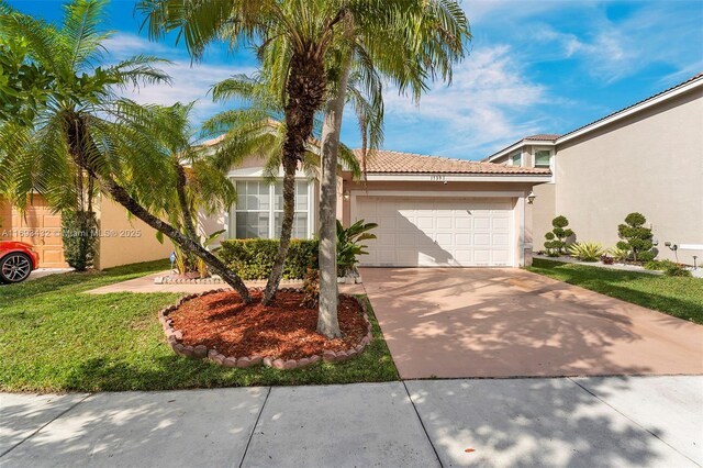 view of side of home with a garage and a lawn