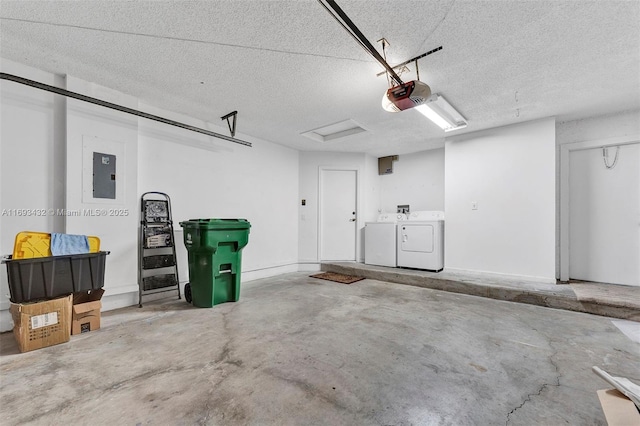 garage featuring washing machine and dryer, electric panel, and a garage door opener