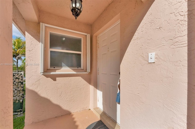 view of exterior entry with stucco siding