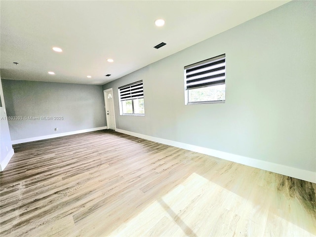 spare room with light hardwood / wood-style flooring