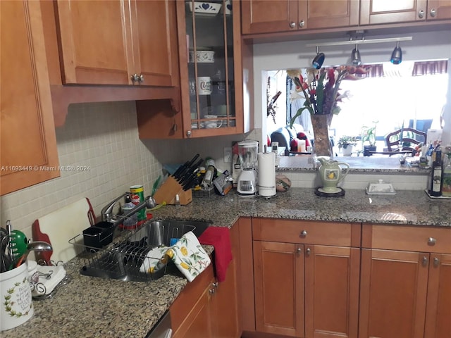 kitchen featuring light stone counters and tasteful backsplash