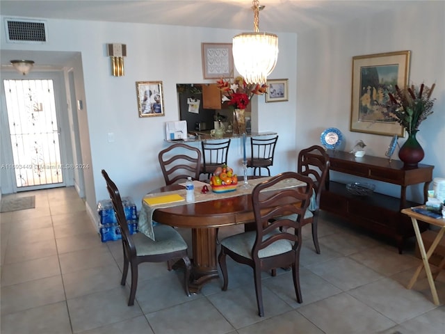 dining area featuring light tile patterned floors and a chandelier