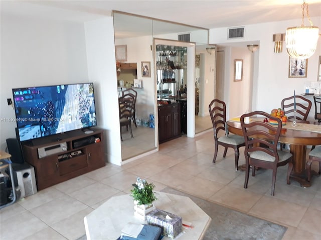 dining space featuring light tile patterned floors and a chandelier