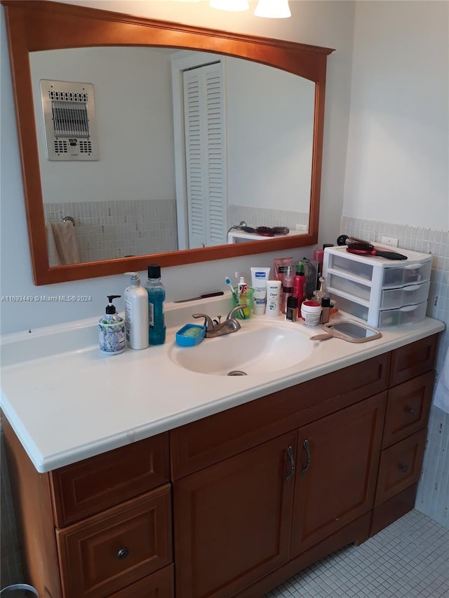 bathroom with vanity, tile patterned flooring, and tile walls