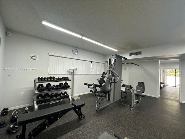 exercise room with a textured ceiling