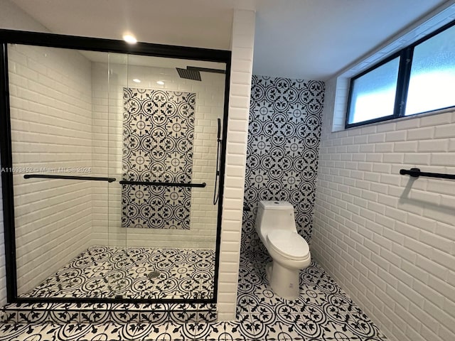 bathroom with toilet, tile patterned flooring, and a shower with door