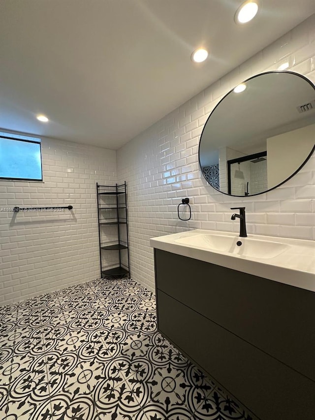 bathroom featuring vanity and brick wall