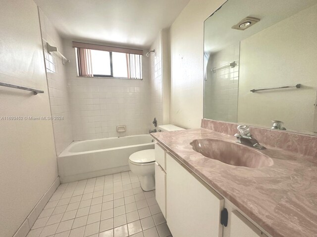 full bathroom with toilet, vanity, tiled shower / bath combo, and tile patterned floors