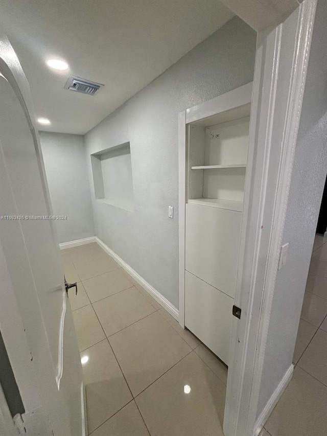 hallway featuring light tile patterned floors