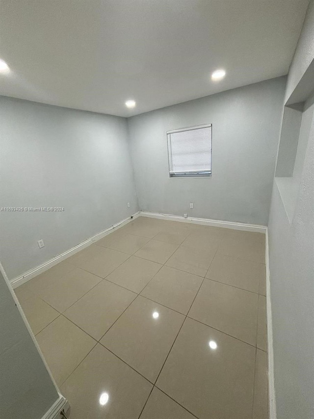 unfurnished room with tile patterned floors