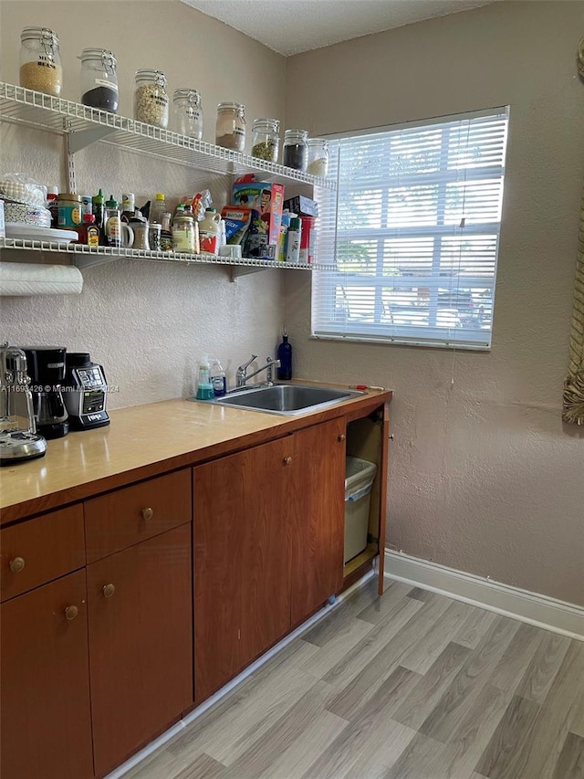 kitchen with sink and light hardwood / wood-style floors