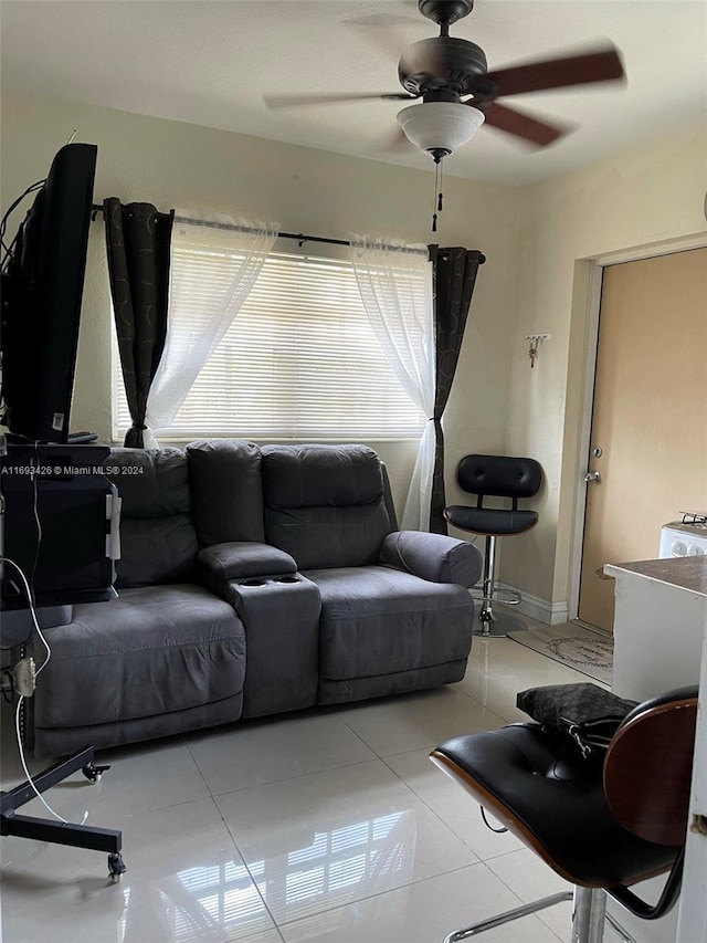 tiled living room with ceiling fan