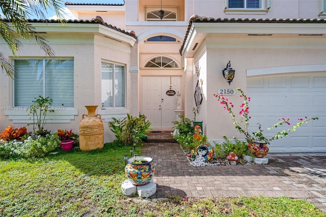 view of exterior entry featuring a garage