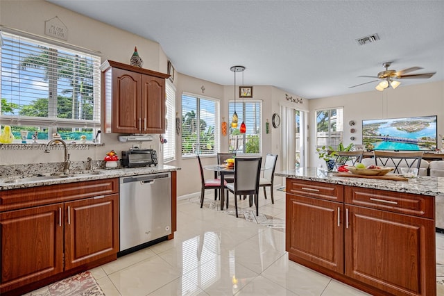 kitchen featuring dishwasher, a wealth of natural light, sink, and pendant lighting