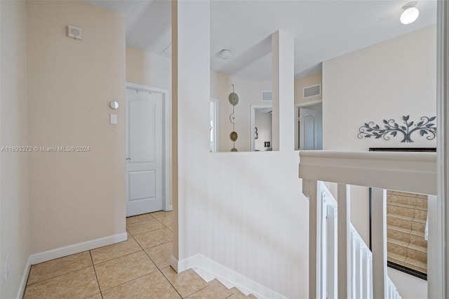 hall with light tile patterned floors