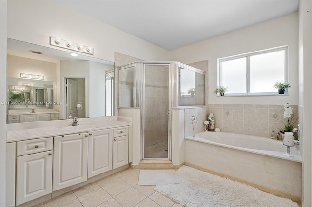 bathroom featuring vanity, tile patterned floors, and separate shower and tub