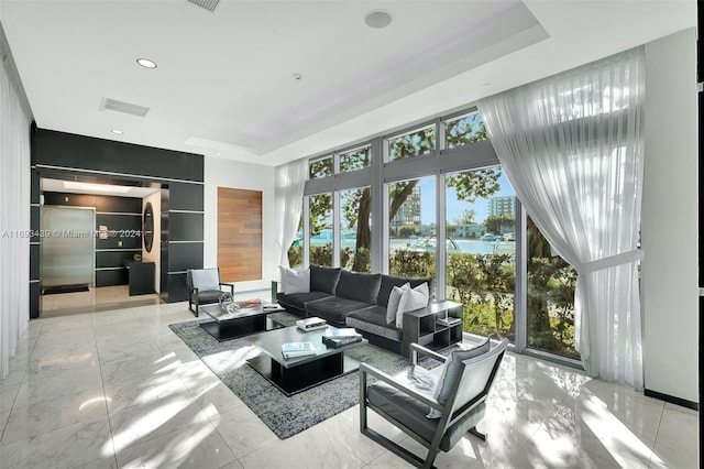 living room featuring a wealth of natural light and a water view