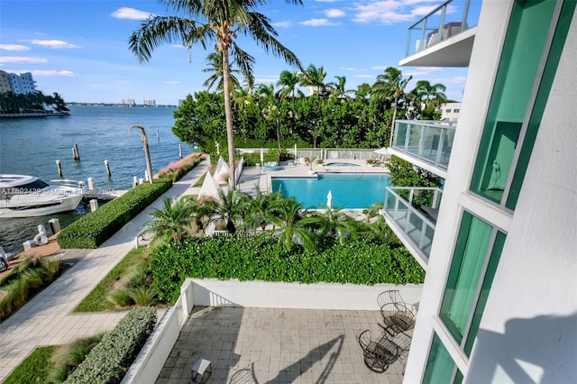 view of swimming pool featuring a water view