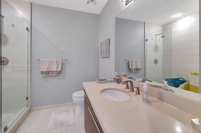 bathroom featuring walk in shower, vanity, toilet, and tile patterned floors