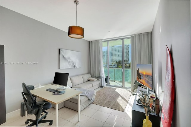 home office featuring a wall of windows and light tile patterned floors