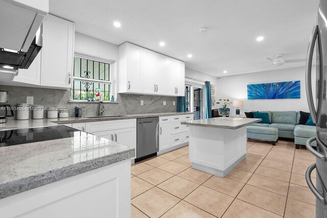 tiled living room featuring ceiling fan