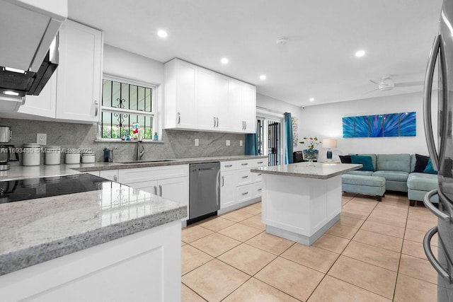 kitchen with white cabinetry, stainless steel appliances, sink, and decorative backsplash