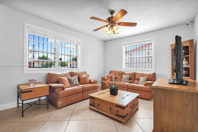 tiled living room with ceiling fan and a wealth of natural light