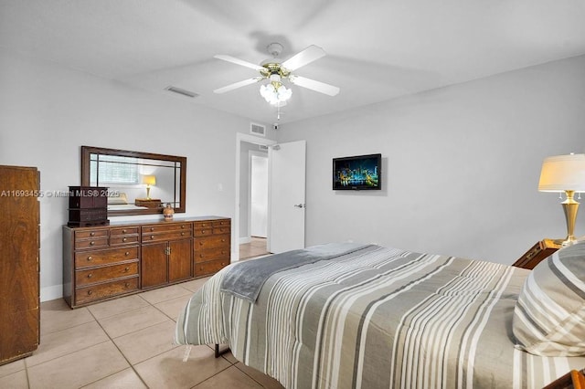 bedroom with ceiling fan and light tile patterned floors