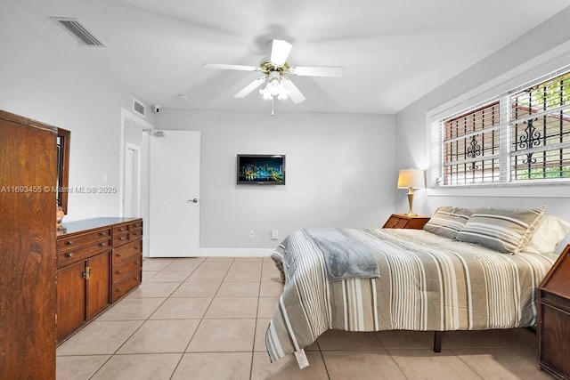 bedroom with ceiling fan and light tile patterned floors