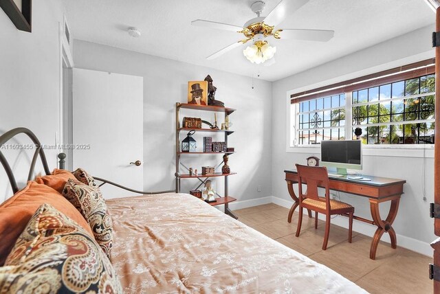 bedroom with ceiling fan and light tile patterned floors