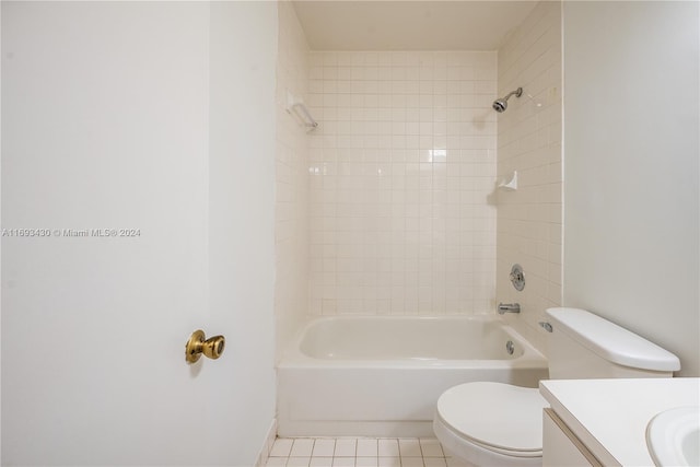 full bathroom featuring tiled shower / bath, tile patterned flooring, vanity, and toilet