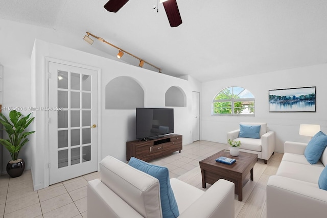 tiled living room with ceiling fan and vaulted ceiling