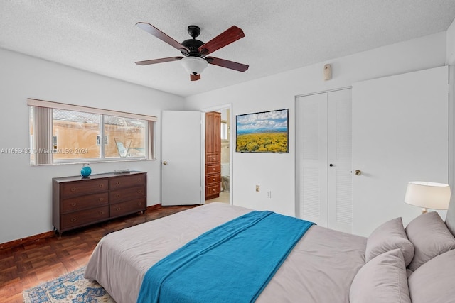 bedroom with a textured ceiling, ceiling fan, and dark parquet floors