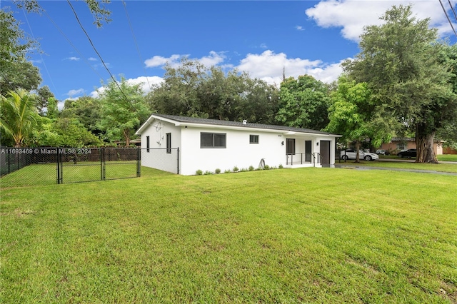 back of property featuring a lawn