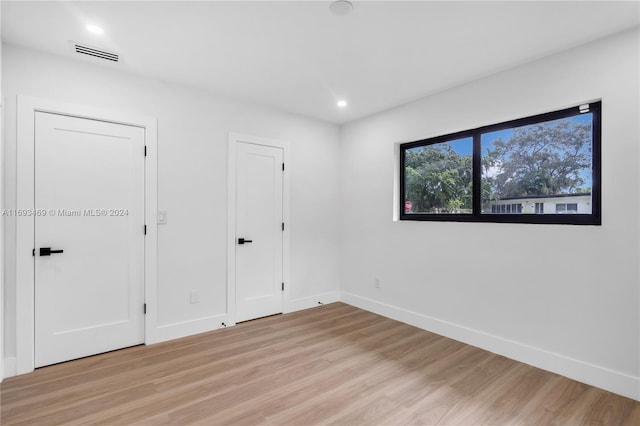 unfurnished room with light hardwood / wood-style floors