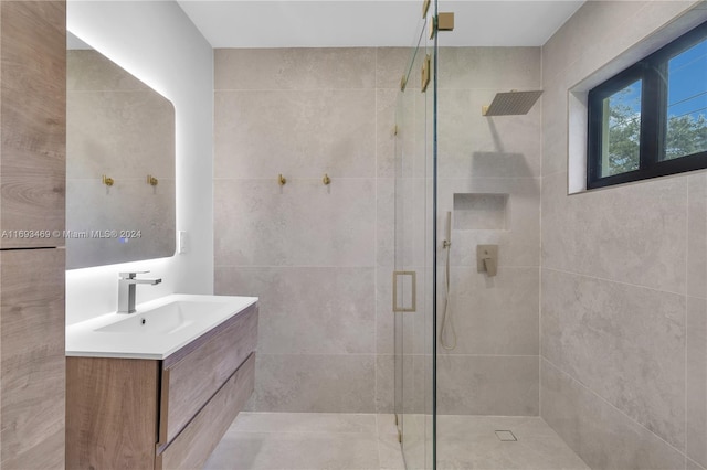 bathroom with vanity and a shower with door