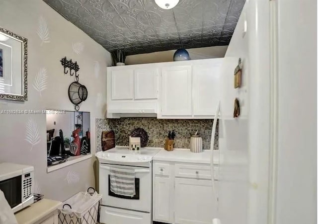 kitchen featuring white appliances, tasteful backsplash, and white cabinetry