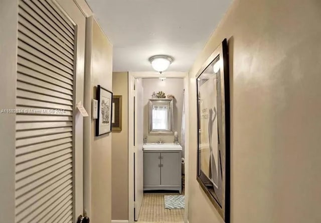 corridor with sink and light tile patterned floors